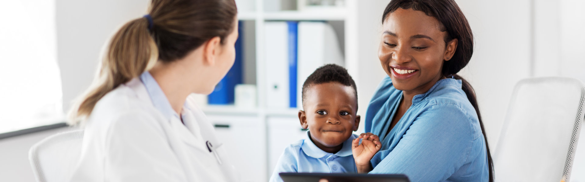 mom and child talking to the doctor