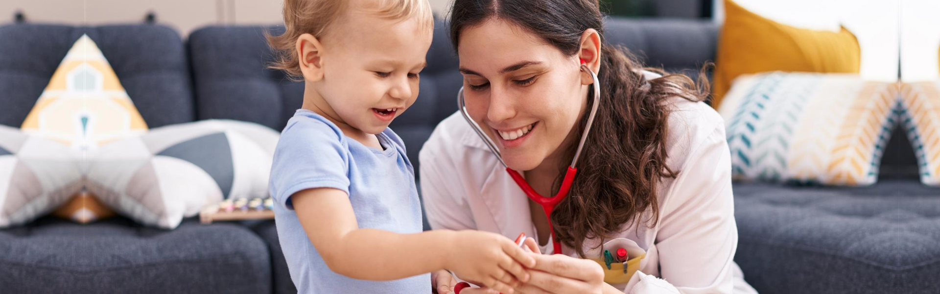 Mother and son doctor examining child at home